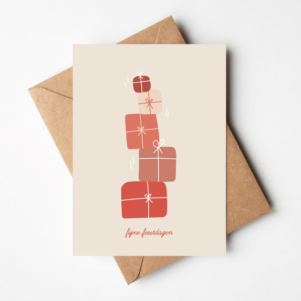 Kerstkaarten kopen. met tekening van vallende pakjes in rode tinten, tekst fijne feestdagen