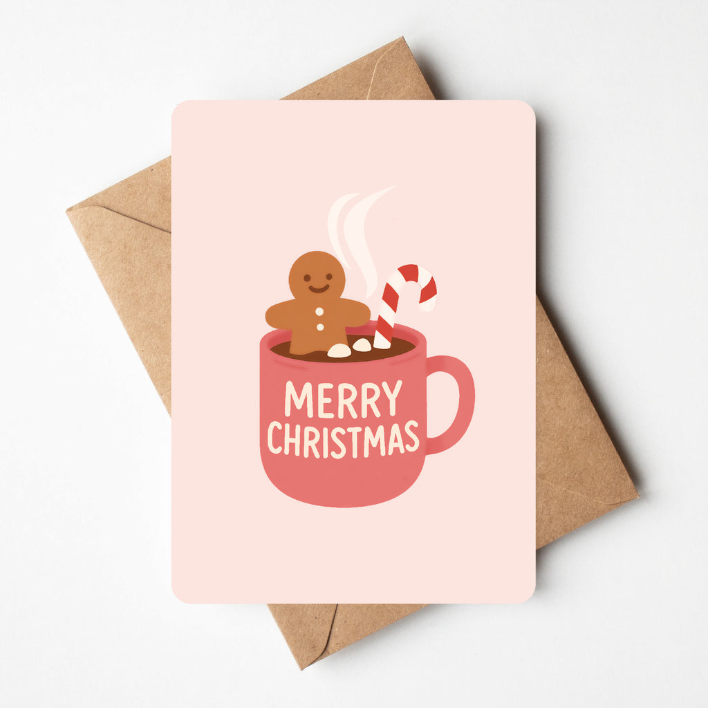 schattige kerstkaart van gingerbread mannetje die in een tas chocomelk zit. 