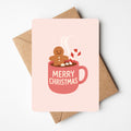 schattige kerstkaart van gingerbread mannetje die in een tas chocomelk zit. 